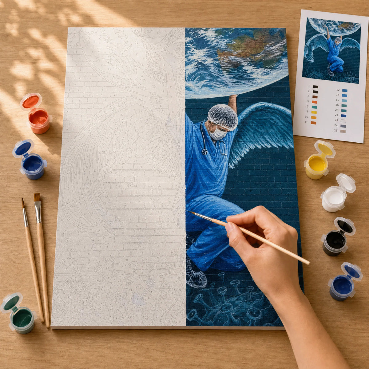 Winged Street Art Paint by Numbers Kit: before and after: numbered canvas and hand painted result