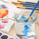 rinsing a blue paint brush clean in a glass of water | Detail Paint Brush Set of 8 + 2 FREE